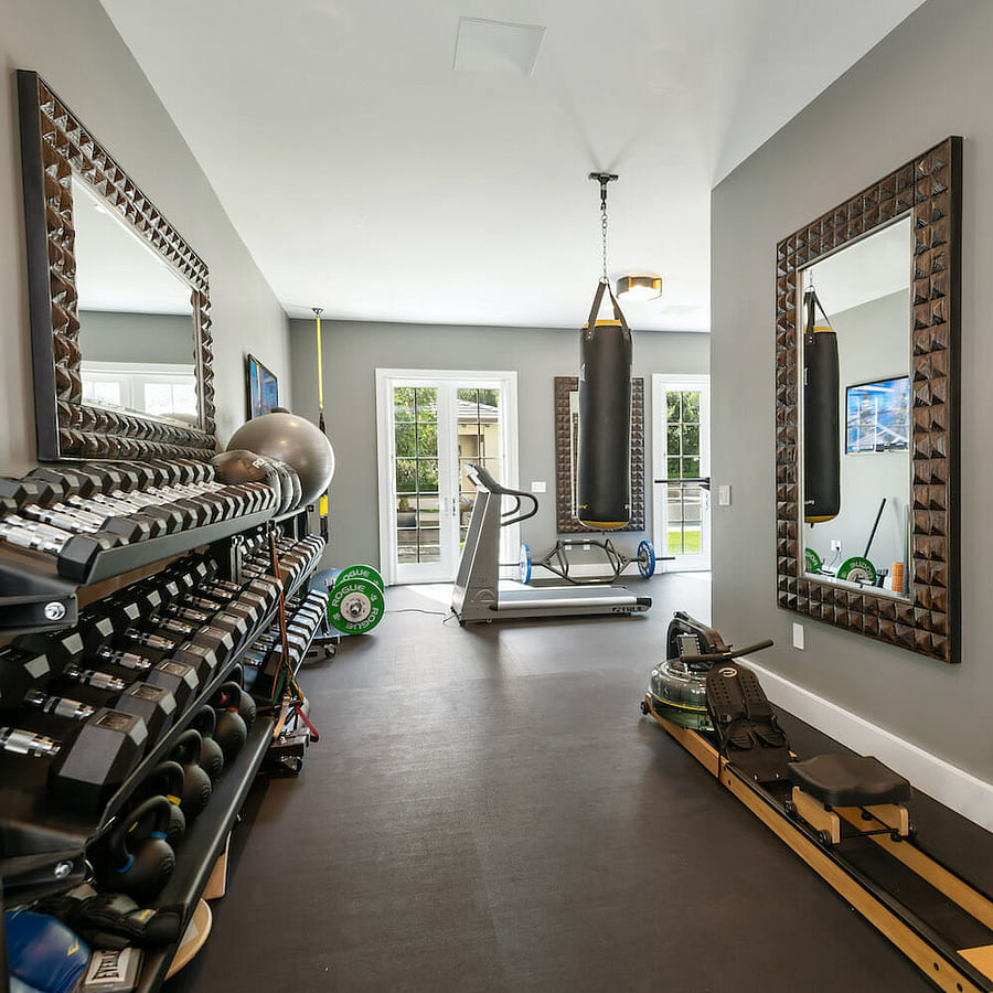 Well-arranged home gym with essential weight lifting equipment