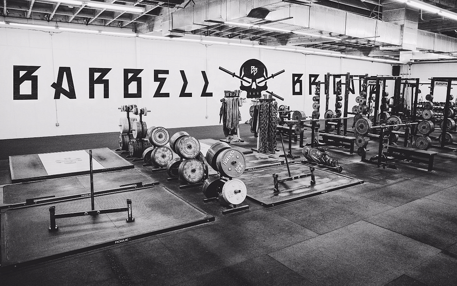 Interior view of Barbell Brigade gym showcasing weightlifting equipment and atmosphere