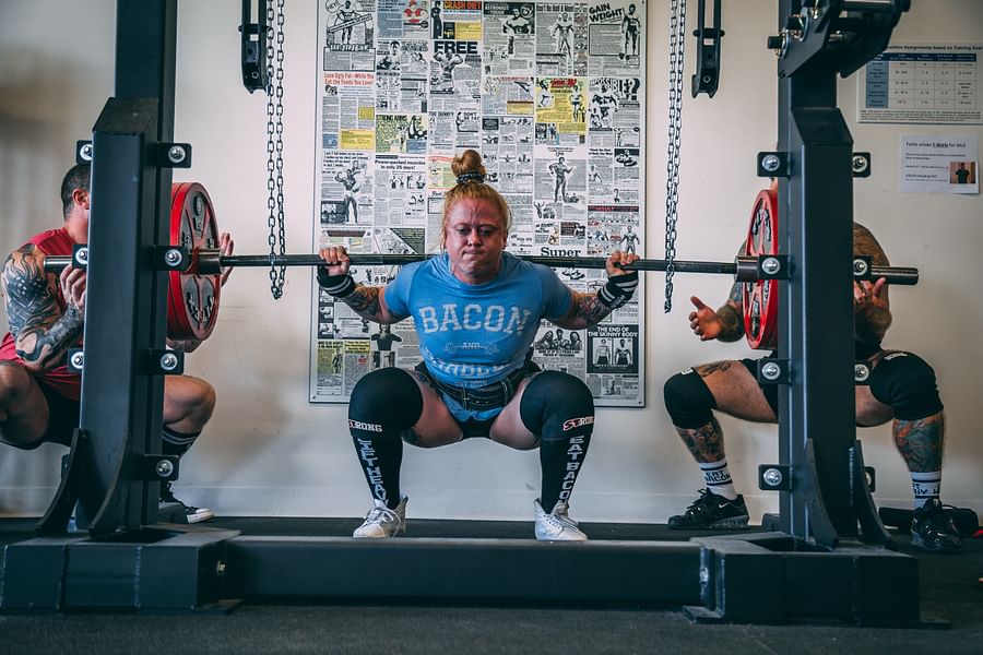Woman performing weightlifting exercise in gym for cellulite reduction